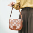 model-holding-brocade-bag-single-hand