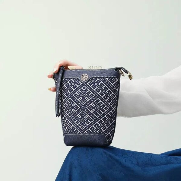 zhuang-brocade-bucket-crossbody-bag-model-blue-dress-sitting-knee zhuang-brocade-bucket-crossbody-bag-model-blue-dress-sitting-knee
